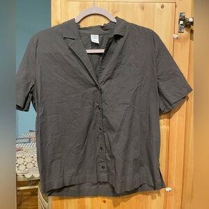 Charcoal-colored women’s button up blouse with ruffle back stitching